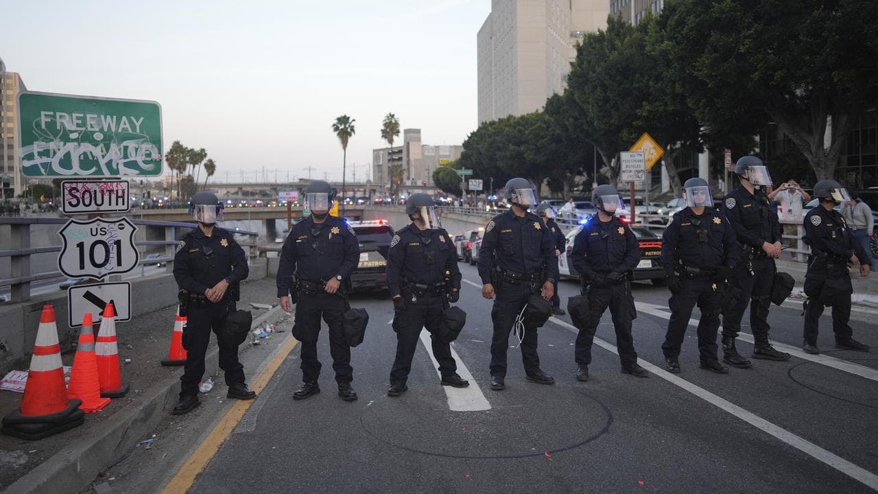 Highway Patrol officers block a US 101 freeway ramp during protests