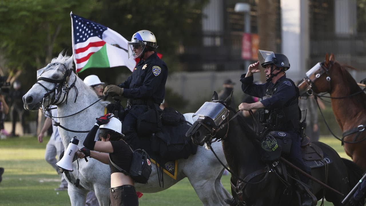 Los Angeles Metro police on horseback disperse protesters