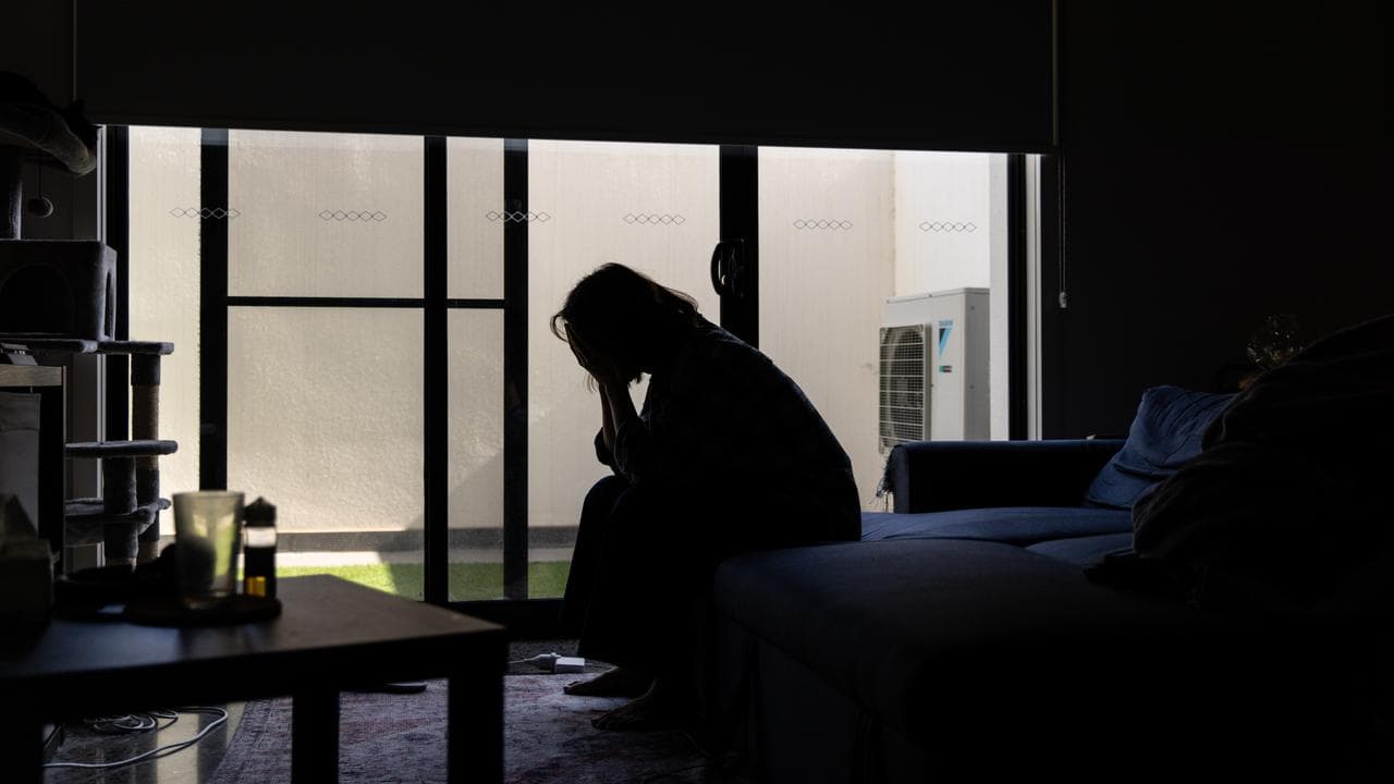 A woman with her head in her hands