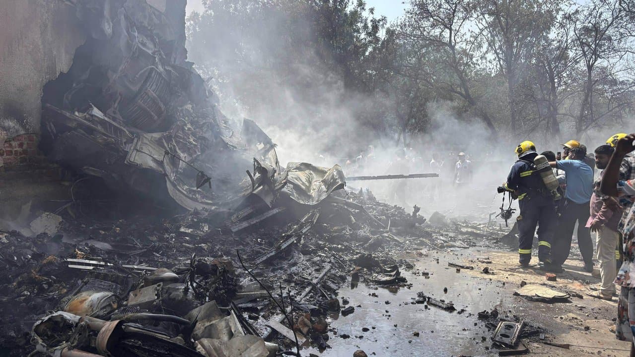 Firefighters at the site of a plane crash in Ahmedabad