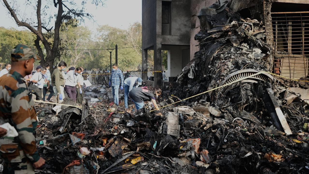 Rescuers work at the site of a plane crash in Ahmedabad