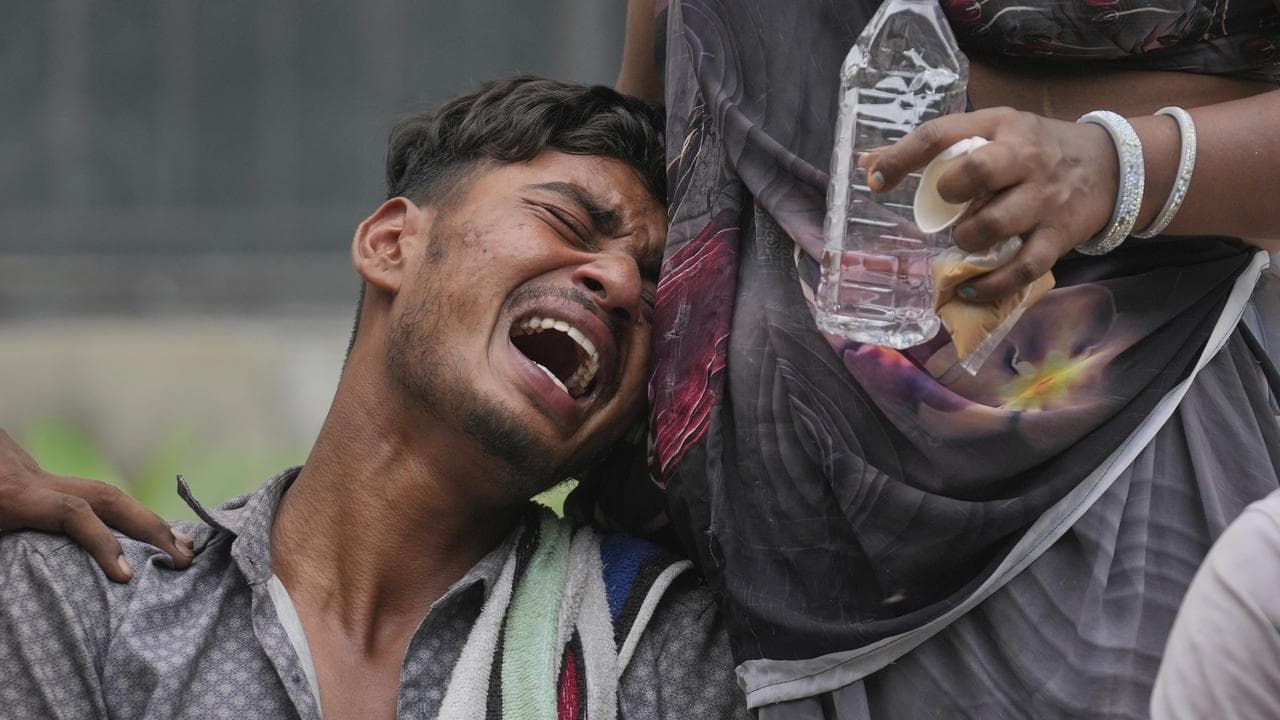 Relative of a boy killed in a plane crash wails outside a hospital