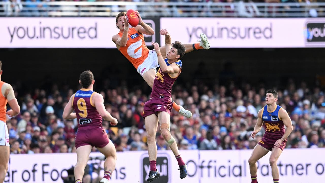 Aaron Cadman takes a screamer over Brisbane's Eric Hipwood.