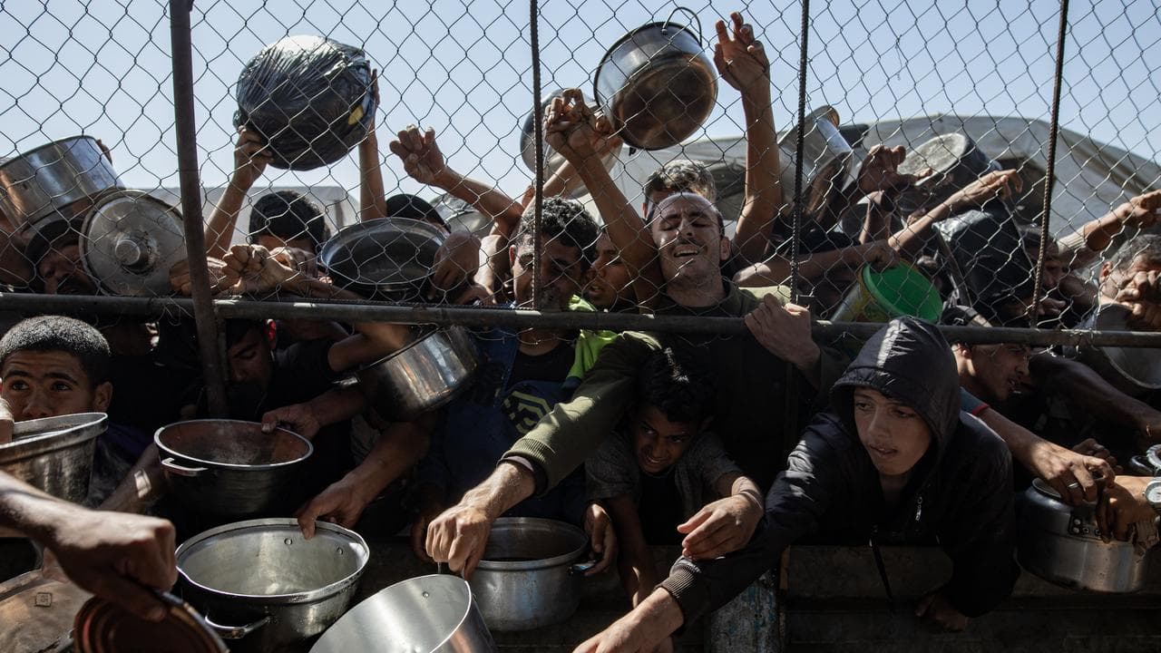 Palestinians gather to receive aid