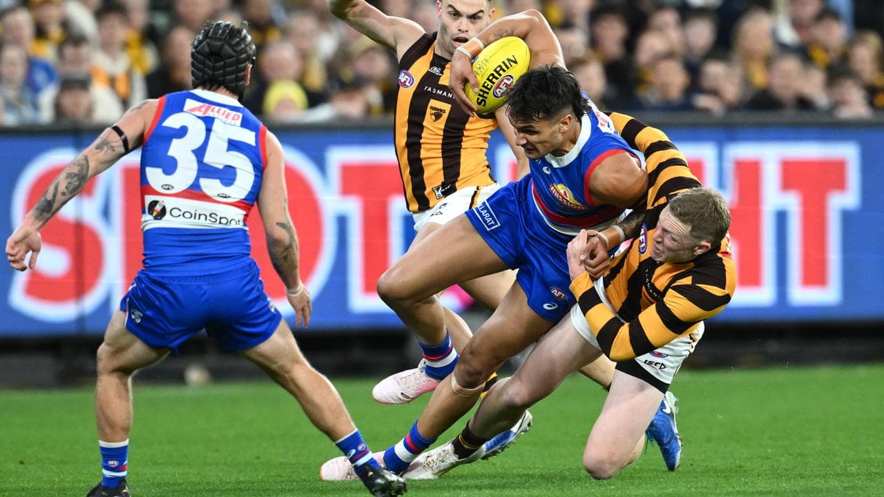 James Sicily of Hawthorn tackles Jamarra Ugle-Hagan.
