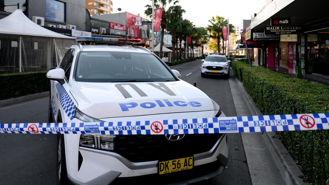 A police car blocks the road