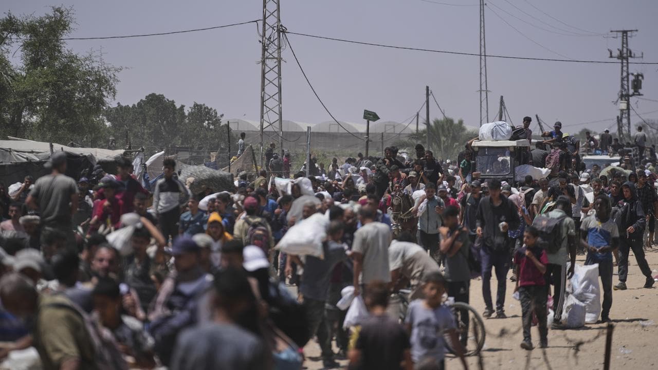 Palestinians carry bags containing food