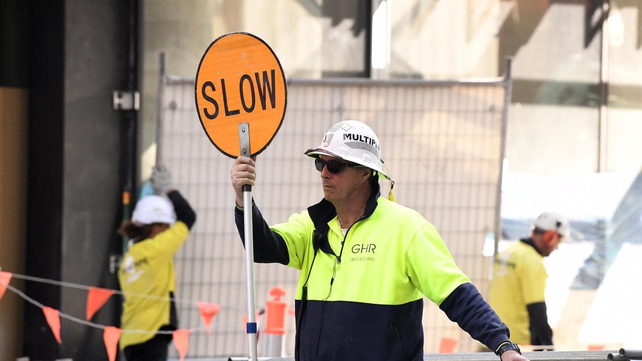 A worker with a slow sign