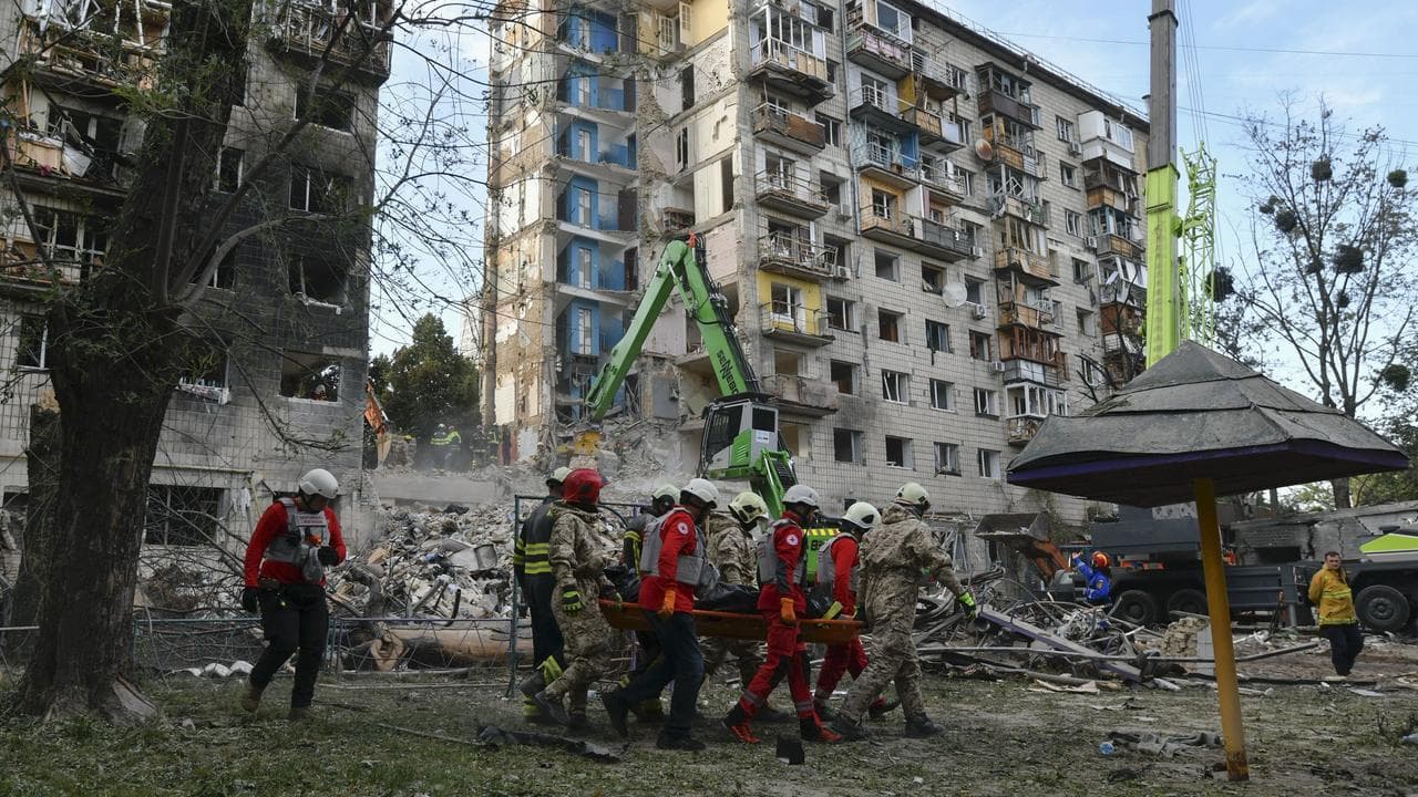 Rescuers carry the body of a victim after a Russian strike in Kyiv
