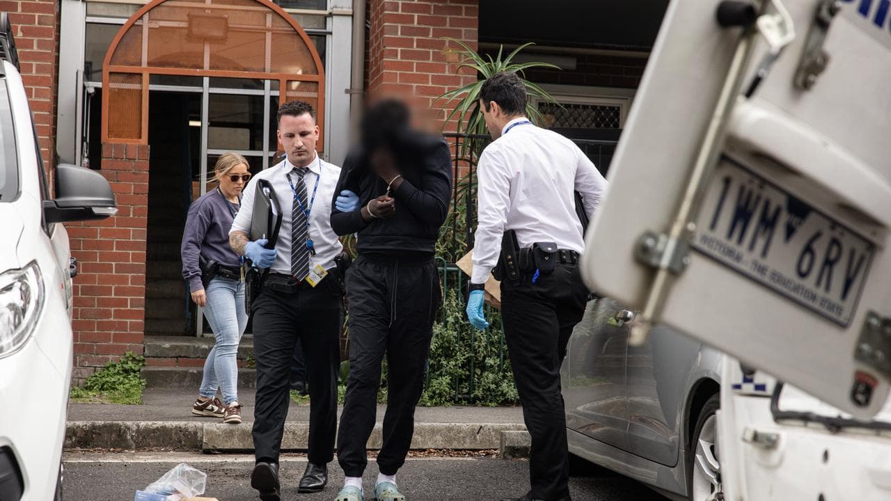 Victoria Police detain a man at the scene of a shooting in Melbourne