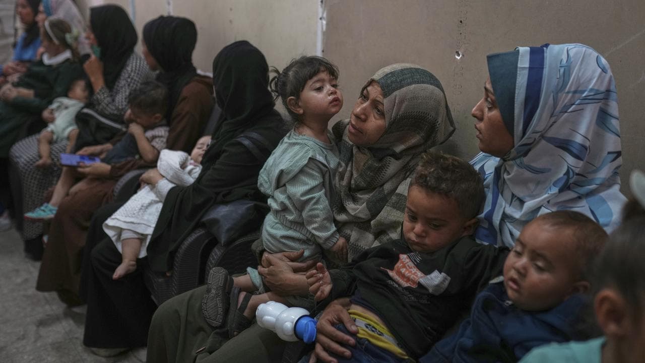 Palestinian women with children waiting for medical care in Gaza