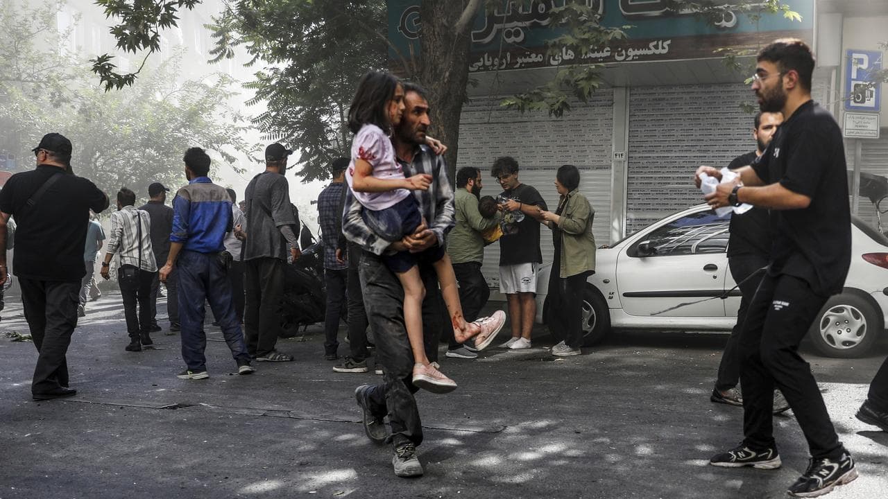 A man carries a wounded girl in Tehran (file image)