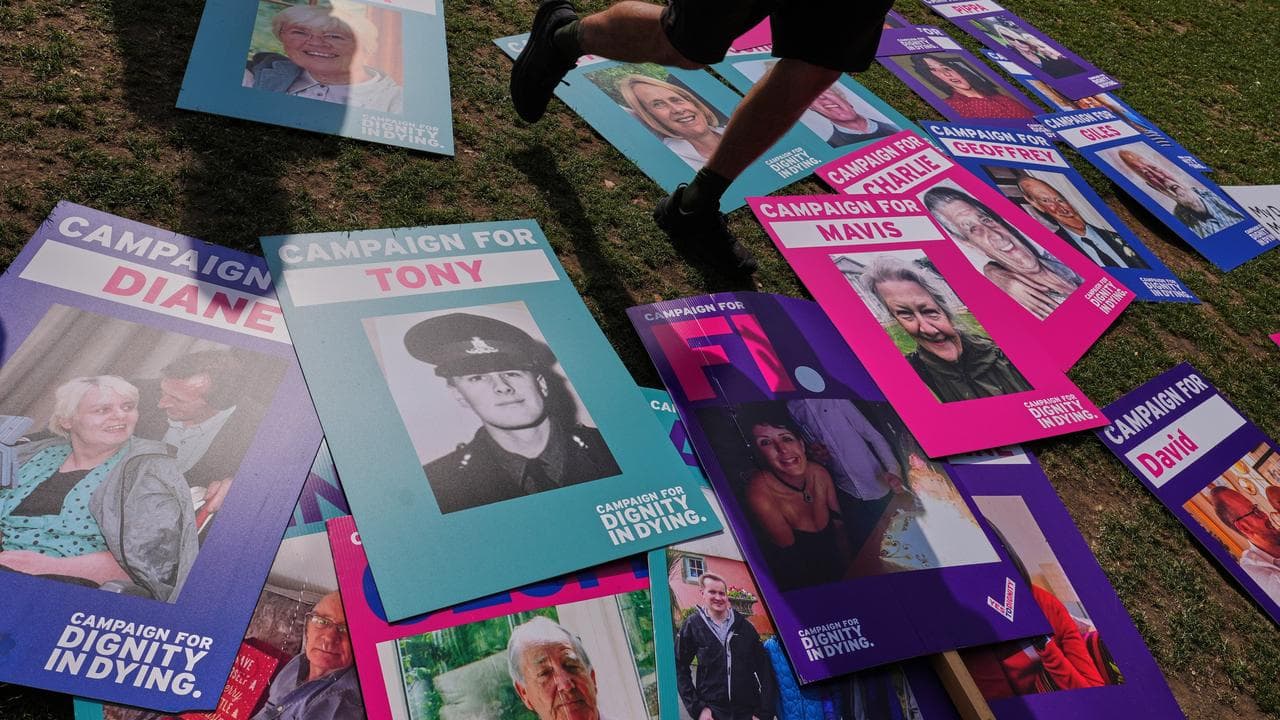 Banners supporting assisted dying lie outside Parliament in London