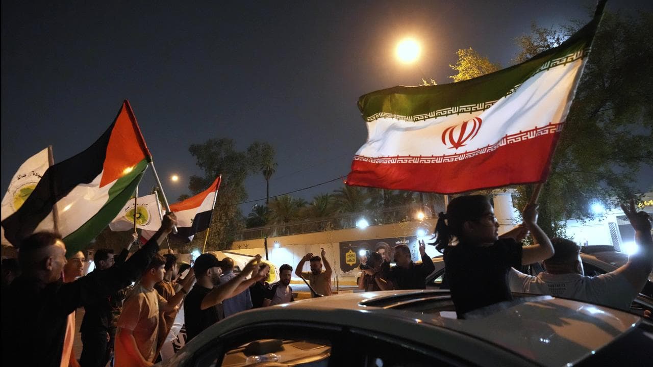 Protesters carry Iranian flags in Baghdad, Iraq