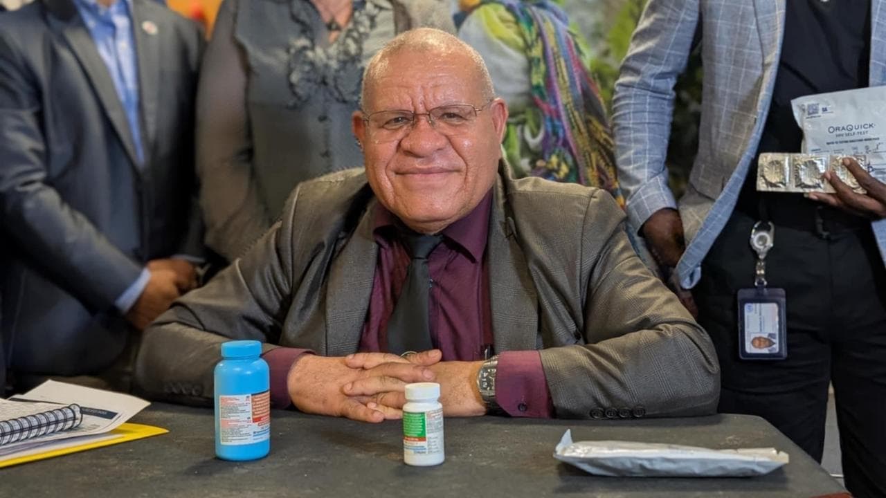 PNG health secretary Ken Wai with HIV antiretroviral medication