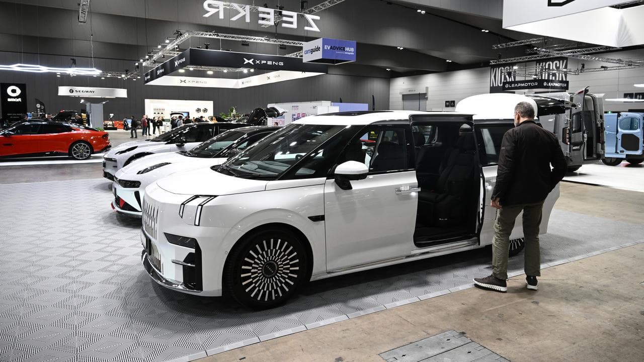 Visitors view vehicles during Melbourne International EV Autoshow.