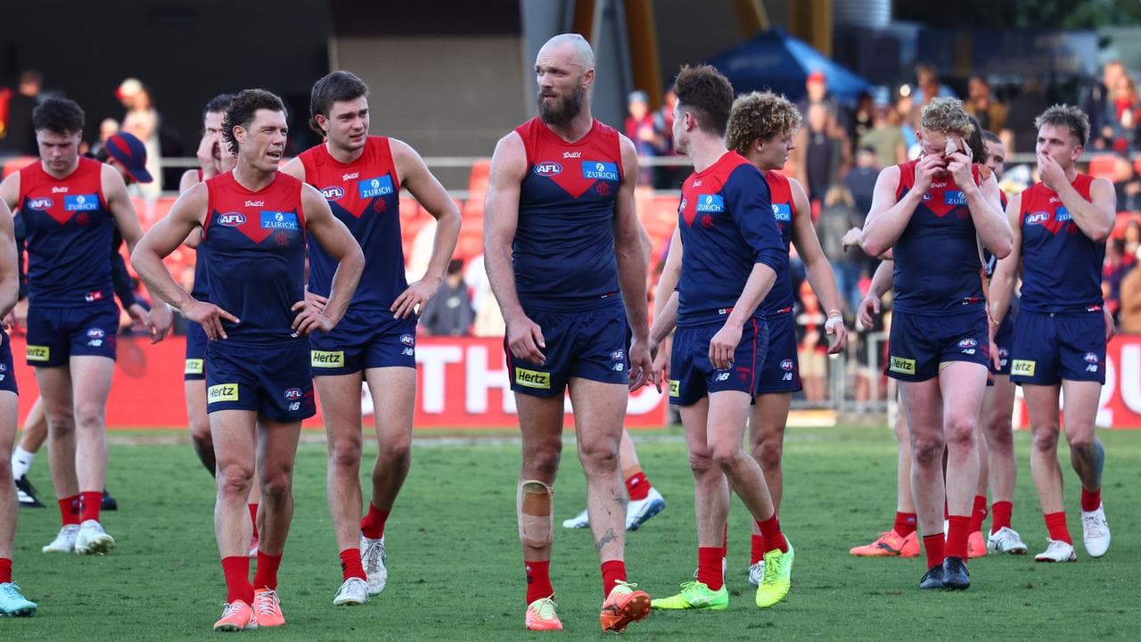 Max Gawn (centre) leads the disappointed Demons off the ground