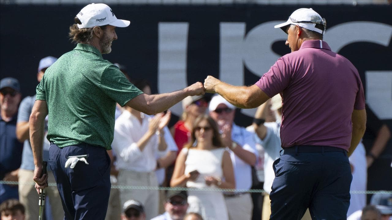 (L-R) Mark Hensby congratulates Padraig Harrington.