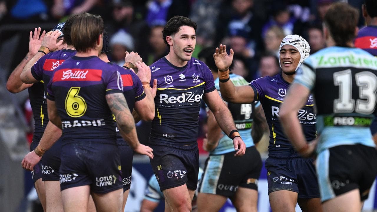 Nick Meaney of the Storm celebrates scoring a try .