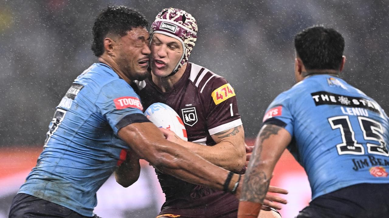 Stefano Utoikamanu (left) tackles Queensland's Kalyn Ponga