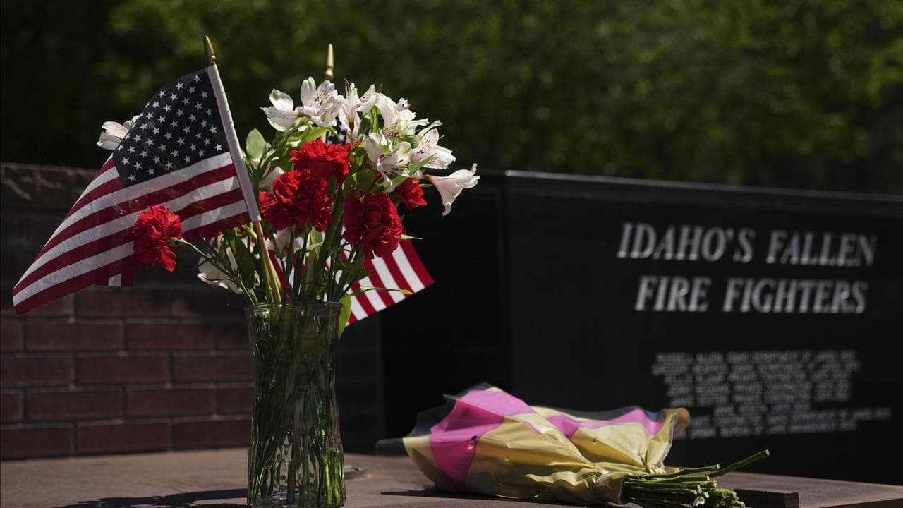 Flowers at the Fallen Heroes Plaza at Cherry Hill Park near the scene