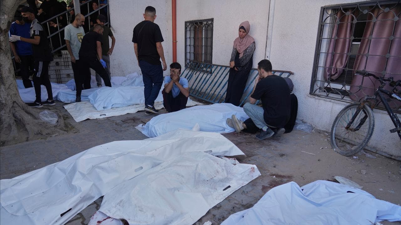 Palestinians mourn people who were killed in Israeli strikes