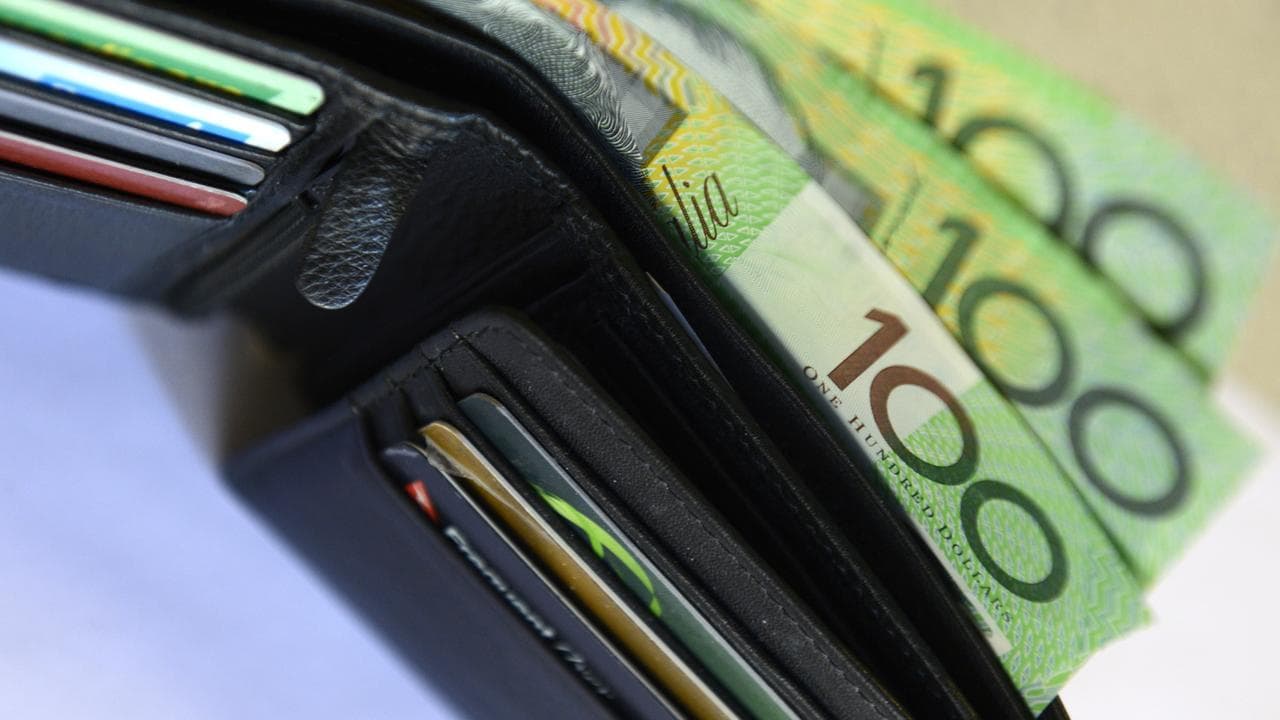 $100 notes pop out of a wallet with credit cards, Aug. 20, 2013