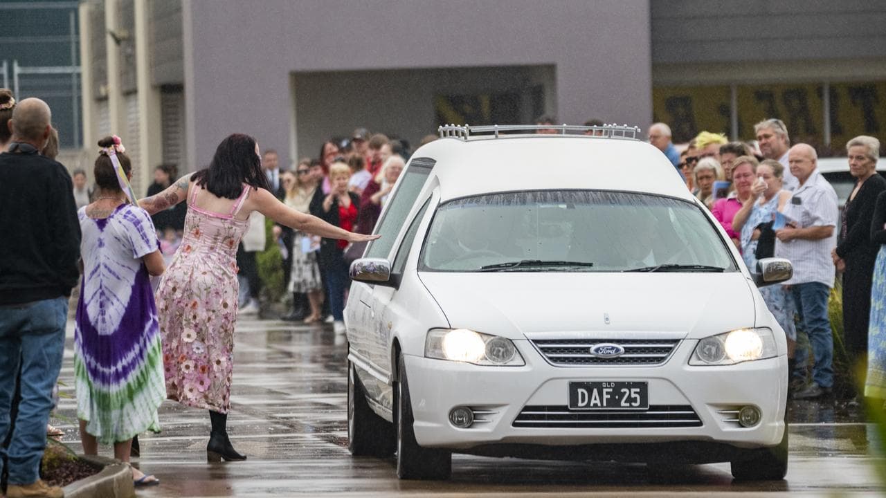 Kylie Johnson touches hearse during a funeral for Pheobe Bishop