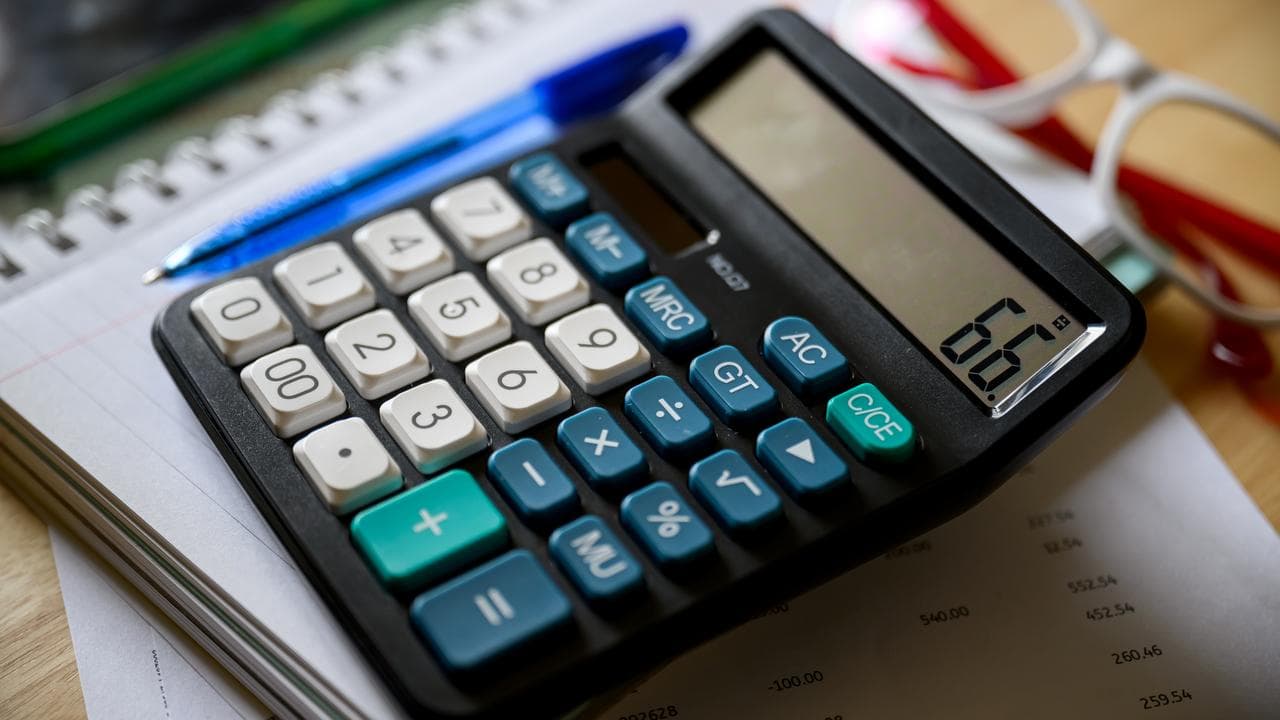 Calculator beside household financial documents 2024. 
