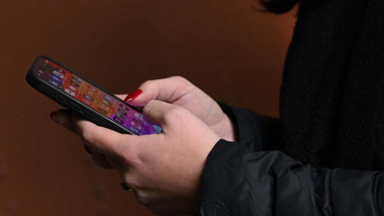 Young person looking at social media on phone