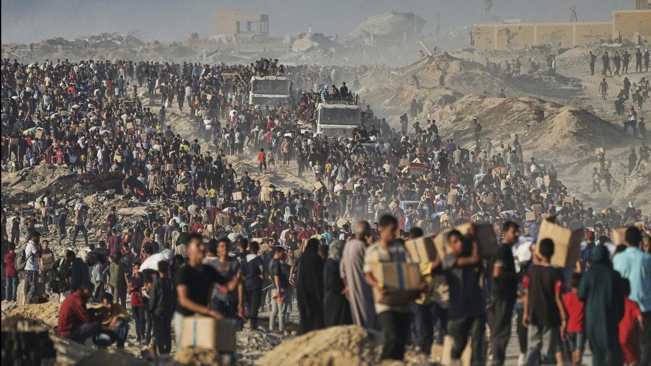 Palestinians carry food and humanitarian aid in Gaza