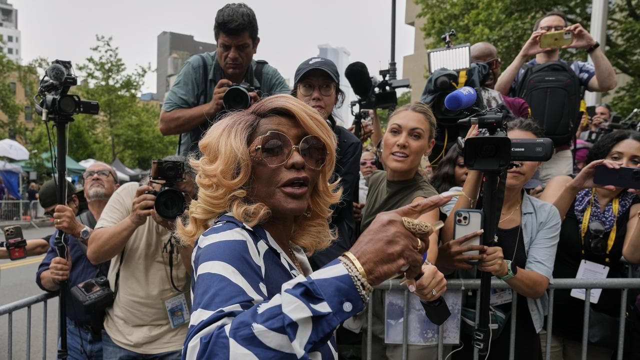 Janice Combs and media outside a Manhattan court
