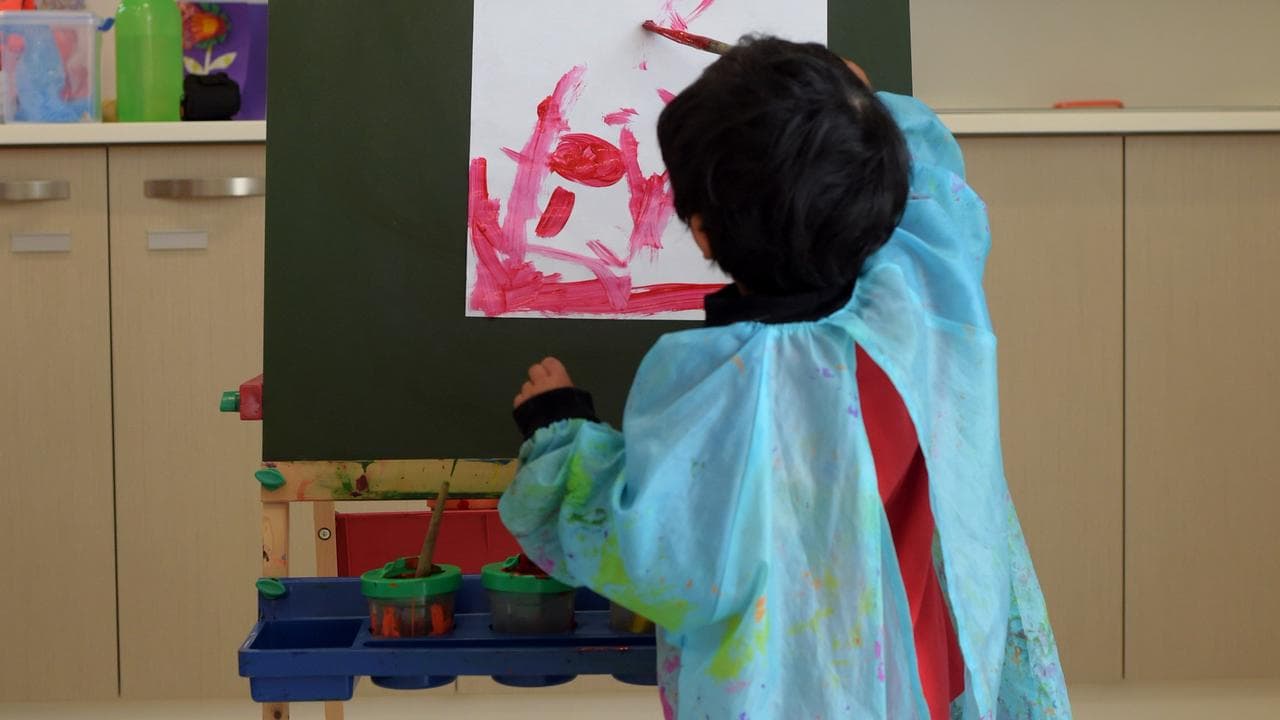 A child paiting at an early education centre