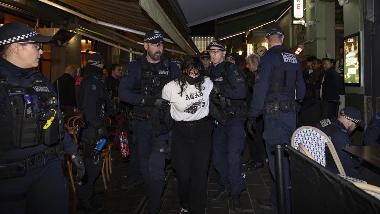 Police escort protesters outside Israeli restaurant Miznon