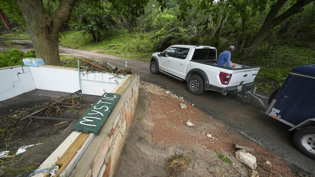 A Camp Mystic sign is seen near the entrance to the establishment
