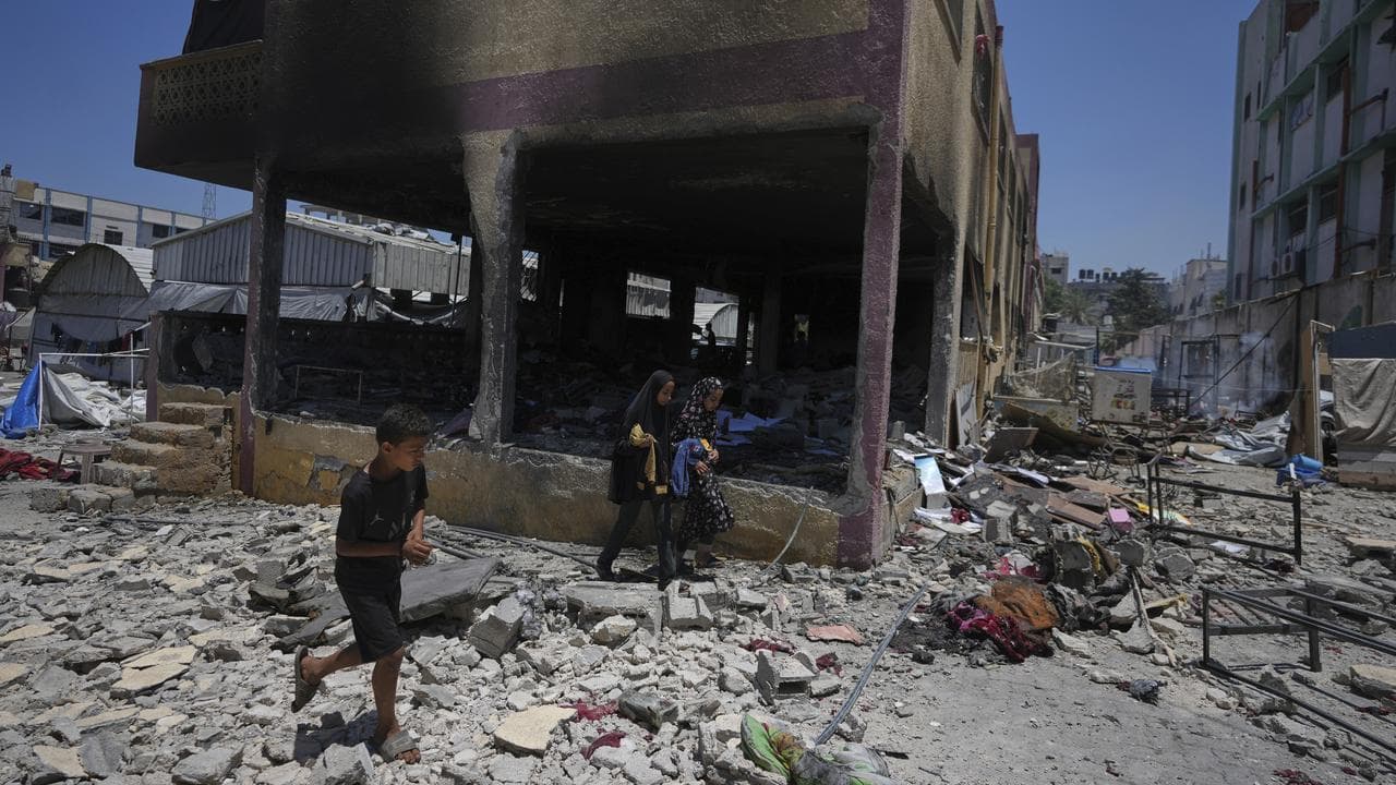 Palestinians survey the destruction in Gaza