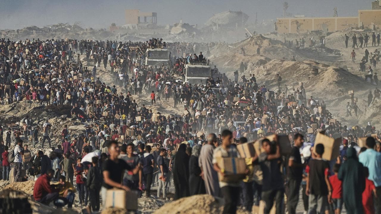 Palestinians carry humanitarian aid in Gaza