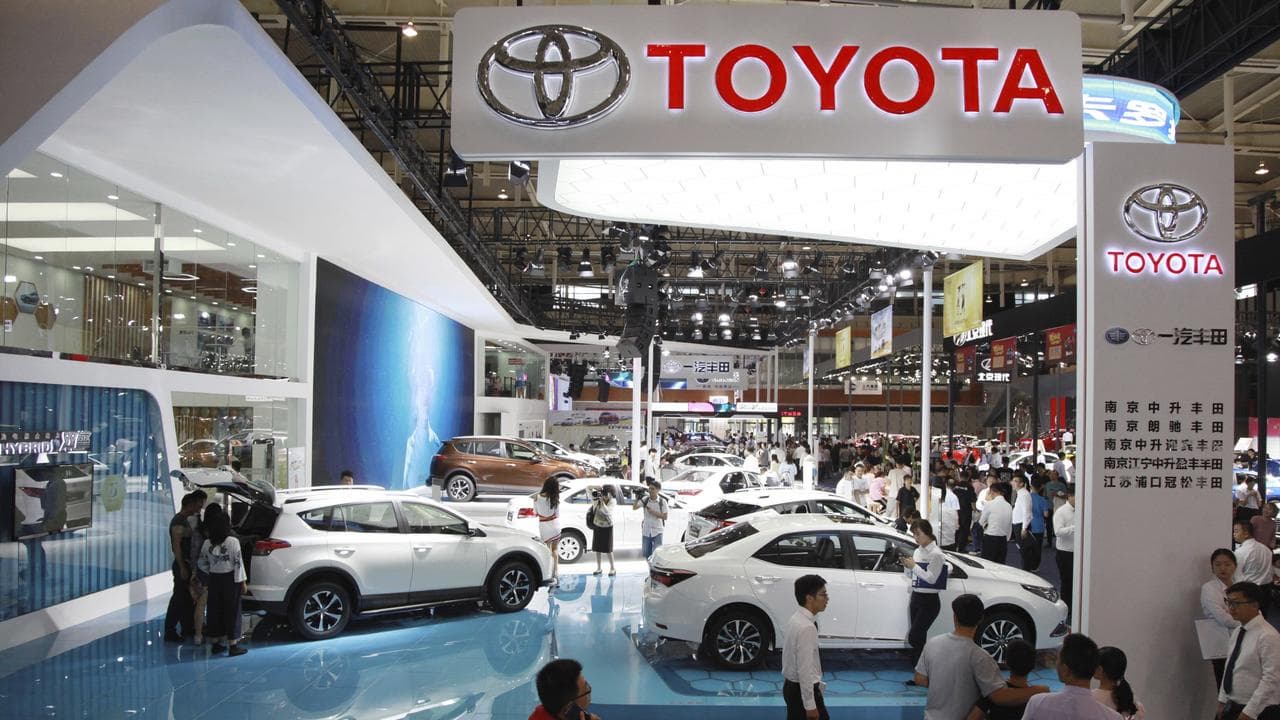 People at the stand of Toyota at an automobile exhibition in Nanjing
