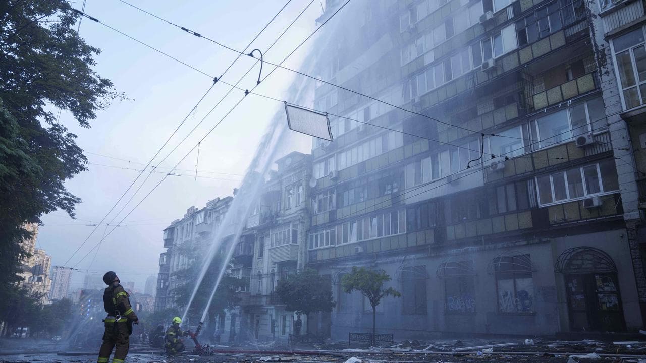 Rescue workers put out a fire after a Russian strike in Kyiv, Ukraine