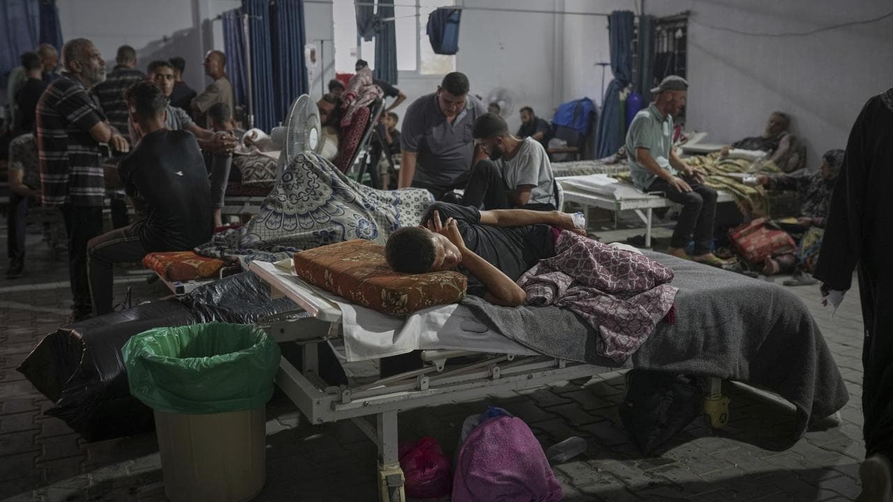 A warehouse in the yard of Shifa Hospital is overcrowded with patients