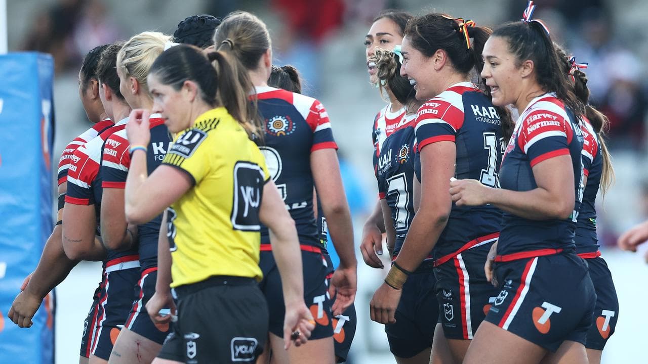 Roosters players celebrate an Olivia Kernick try