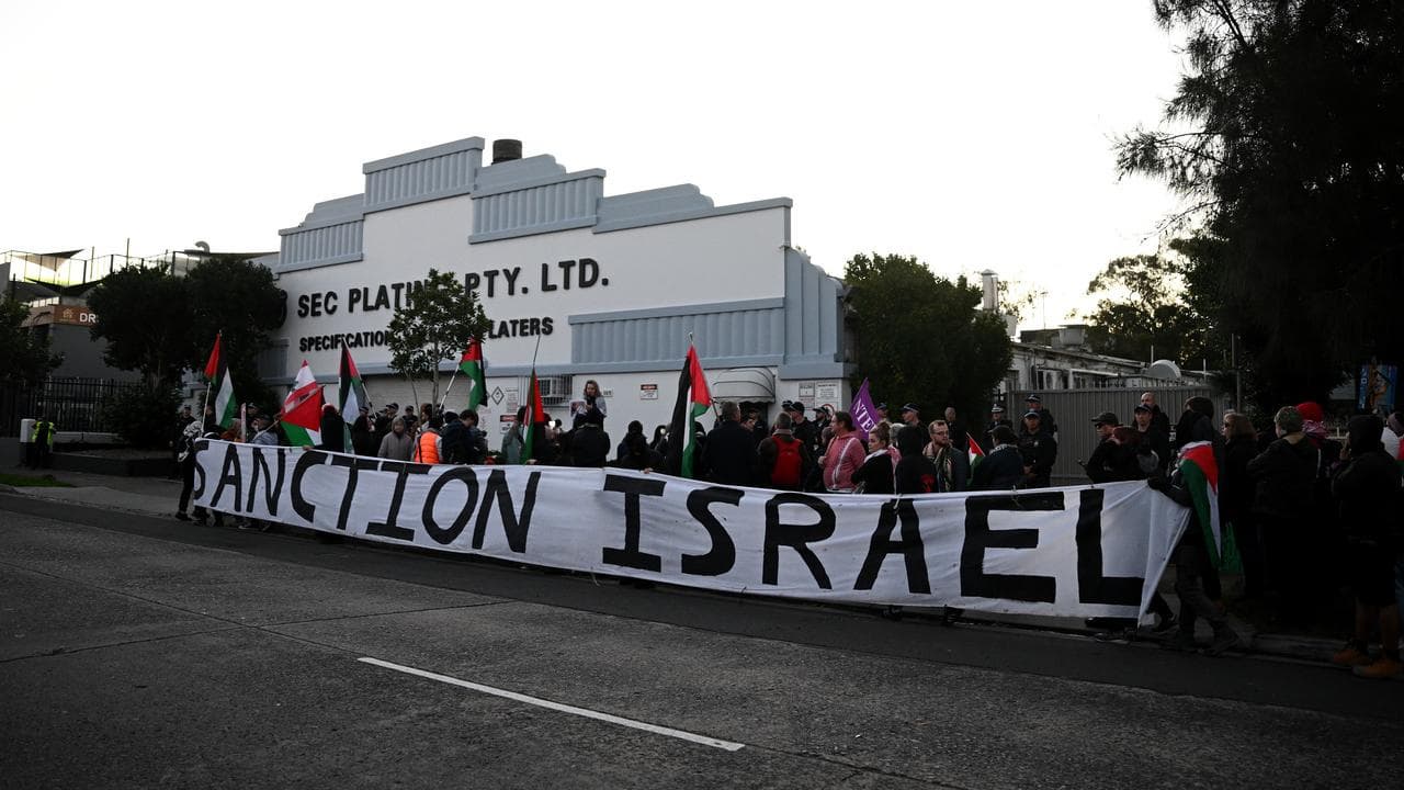 Protesters gather during a rally at SEC Plating in Belmore on Friday