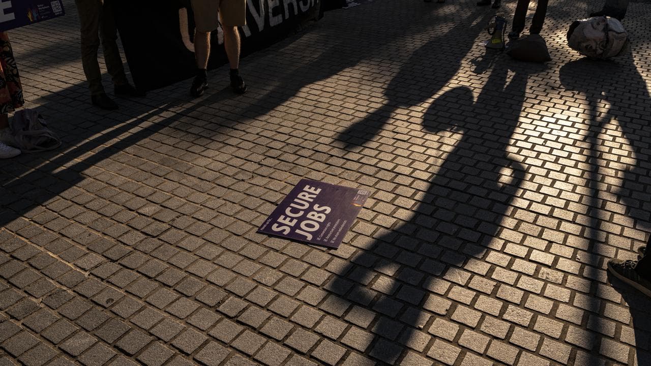 A sign on the ground at a university protest