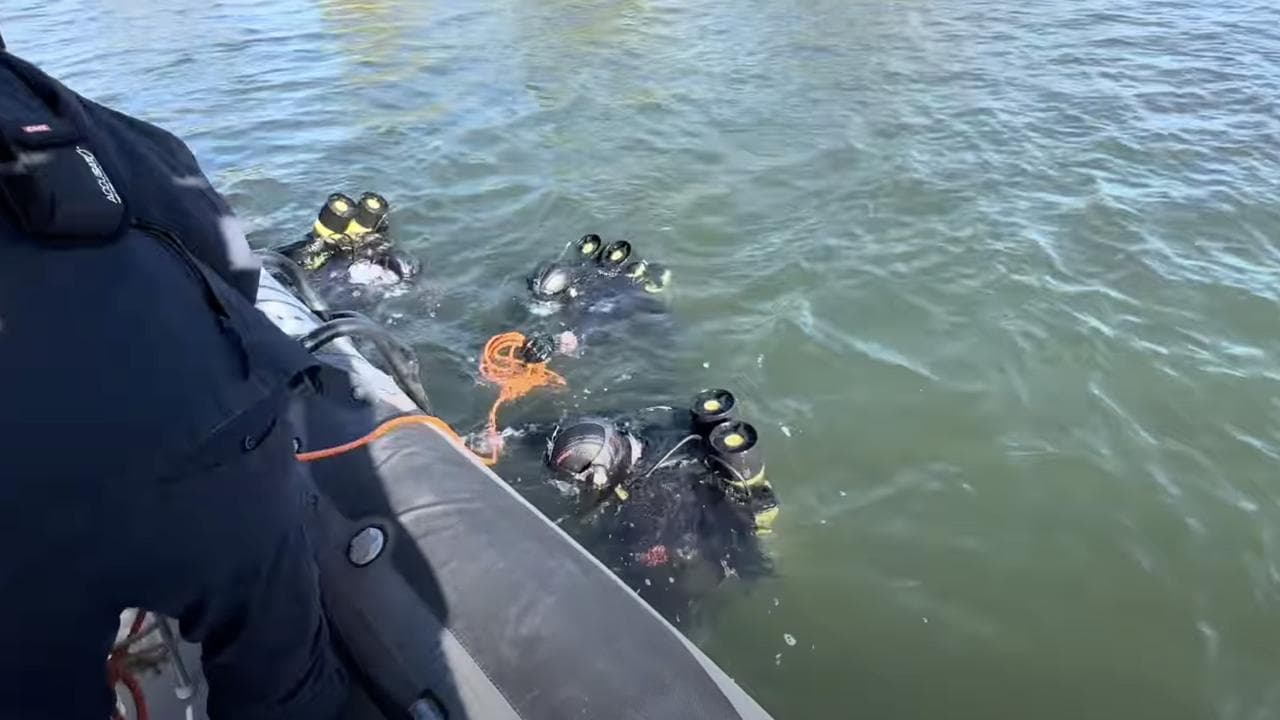 Police divers searching the Port River estuary, SA