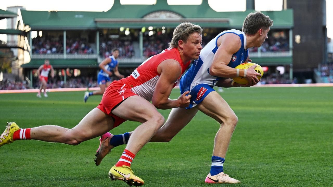 Isaac Heeney tried to stop North Melbouirne's Dylan Stephens