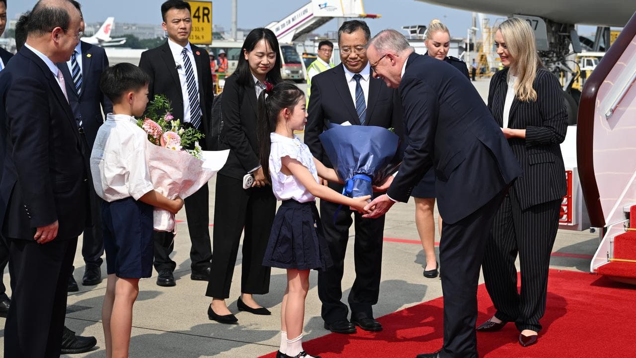 Anthony Albanese and partner Jodie Haydon arriving in Chengdu