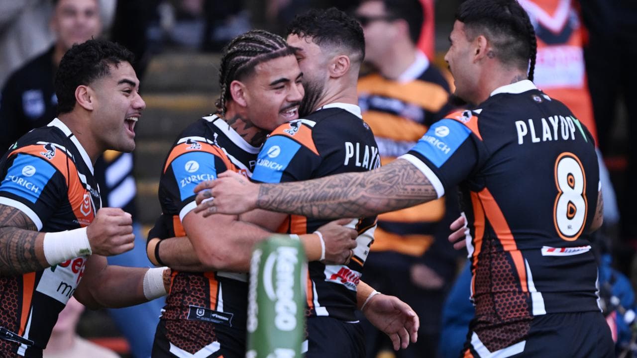 Wests Tigers players celebrate Taylan May’s try.