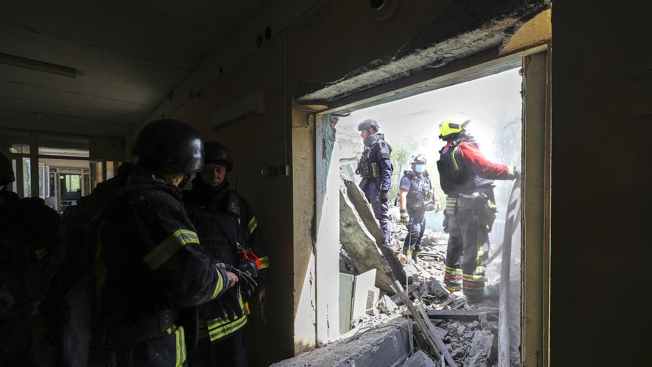Rescue workers at the site of glide bomb strike