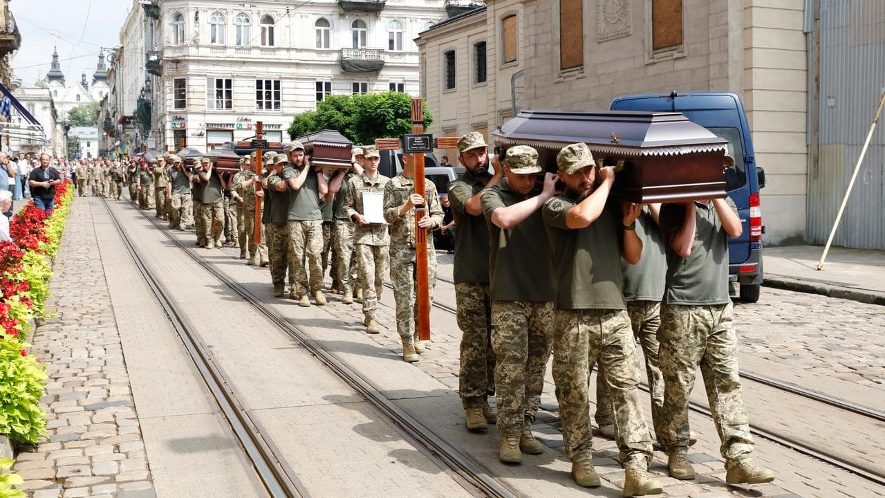 Servicemen carry coffins of Ukrainian soldiers
