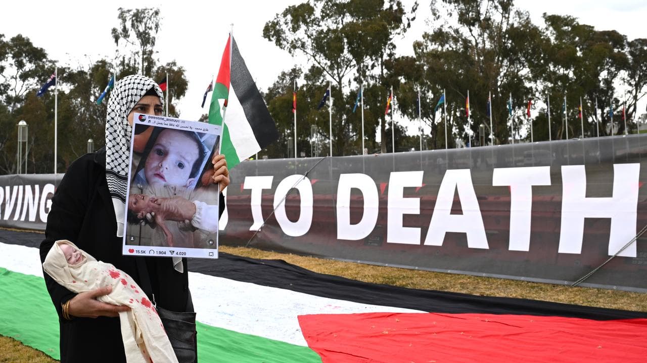 People participate in a rally calling for sanctions against Israel